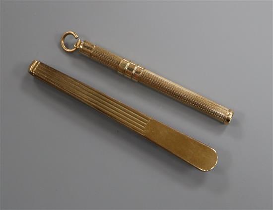A 9ct gold tie clip and a 9ct gold propelling toothpick.